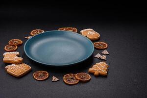 Empty round ceramic copy space plate with gingerbread cookies and Christmas elements photo