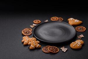 Empty round ceramic copy space plate with gingerbread cookies and Christmas elements photo