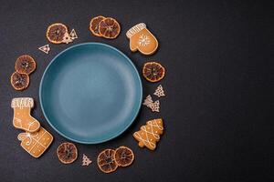 Empty round ceramic copy space plate with gingerbread cookies and Christmas elements photo
