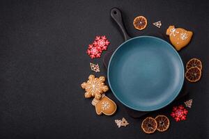 Empty round ceramic copy space plate with gingerbread cookies and Christmas elements photo