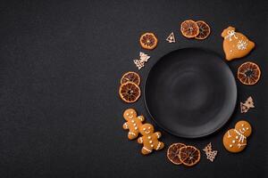Empty round ceramic copy space plate with gingerbread cookies and Christmas elements photo