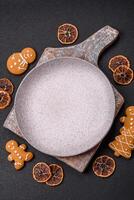 Empty round ceramic copy space plate with gingerbread cookies and Christmas elements photo
