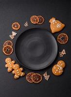Empty round ceramic copy space plate with gingerbread cookies and Christmas elements photo