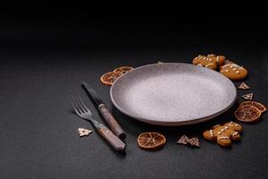 Empty round ceramic copy space plate with gingerbread cookies and Christmas elements photo