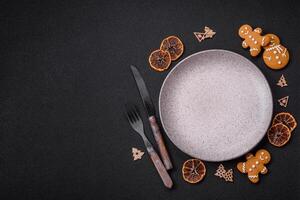 Empty round ceramic copy space plate with gingerbread cookies and Christmas elements photo