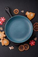 Empty round ceramic copy space plate with gingerbread cookies and Christmas elements photo