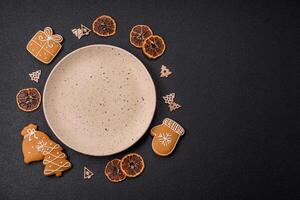 Empty round ceramic copy space plate with gingerbread cookies and Christmas elements photo