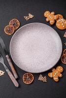 Empty round ceramic copy space plate with gingerbread cookies and Christmas elements photo
