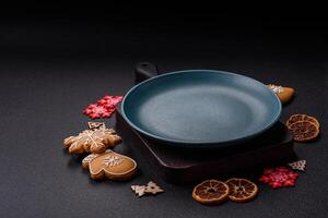 Empty round ceramic copy space plate with gingerbread cookies and Christmas elements photo