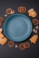 Empty round ceramic copy space plate with gingerbread cookies and Christmas elements photo