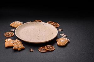 Empty round ceramic copy space plate with gingerbread cookies and Christmas elements photo