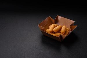 Fast food breaded cheese sticks with salt and spices photo