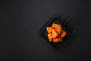 Breaded camembert or brie cheese baked in the form of nuggets with salt and spices photo