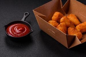 Breaded camembert or brie cheese baked in the form of nuggets with salt and spices photo