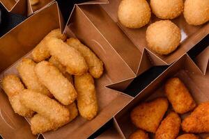 Fast food french fries, brie fries, cheese balls, cheese sticks and chicken nuggets photo