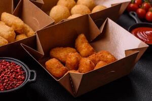 Fast food french fries, brie fries, cheese balls, cheese sticks and chicken nuggets photo