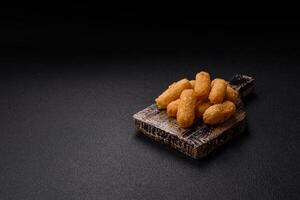 Fast food breaded cheese sticks with salt and spices photo
