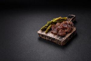 Juicy beef or pork cut into slices with boiled asparagus photo