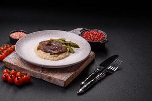 Juicy beef or pork cut into slices with boiled asparagus photo