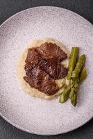 Juicy beef or pork cut into slices with boiled asparagus photo
