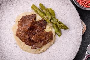 Juicy beef or pork cut into slices with boiled asparagus photo