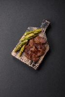 Juicy beef or pork cut into slices with boiled asparagus photo