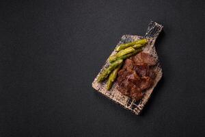Juicy beef or pork cut into slices with boiled asparagus photo