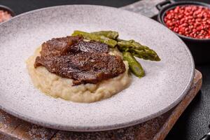 Juicy beef or pork cut into slices with boiled asparagus photo