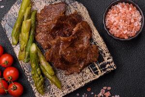 Juicy beef or pork cut into slices with boiled asparagus photo