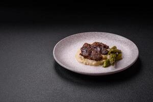 Juicy beef or pork cut into slices with boiled asparagus photo