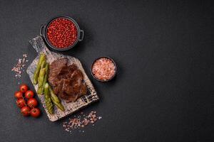 Juicy beef or pork cut into slices with boiled asparagus photo
