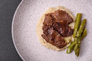 Juicy beef or pork cut into slices with boiled asparagus photo