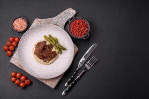 Juicy beef or pork cut into slices with boiled asparagus photo