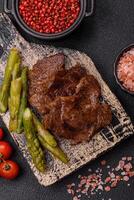 Juicy beef or pork cut into slices with boiled asparagus photo