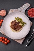 Juicy beef or pork cut into slices with boiled asparagus photo