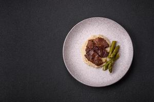 Juicy beef or pork cut into slices with boiled asparagus photo