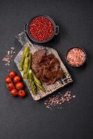 Juicy beef or pork cut into slices with boiled asparagus photo