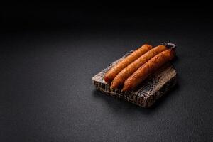 Juicy fried beef or pork sausages with salt, spices and herbs photo