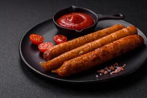 Juicy fried beef or pork sausages with salt, spices and herbs photo
