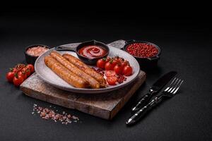 Juicy fried beef or pork sausages with salt, spices and herbs photo