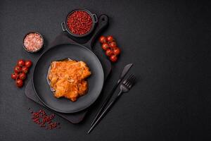 Sliced fish in tomato sauce with salt and spices photo