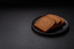 Fresh crispy brown bread sliced from whole grain flour photo