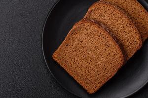 Fresh crispy brown bread sliced from whole grain flour photo