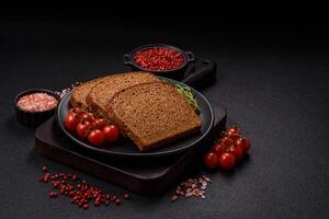 Fresh crispy brown bread sliced from whole grain flour photo