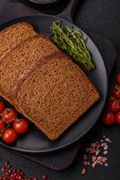 Fresh crispy brown bread sliced from whole grain flour photo