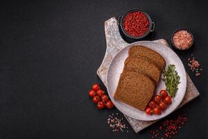 Fresh crispy brown bread sliced from whole grain flour photo