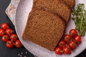 Fresh crispy brown bread sliced from whole grain flour photo