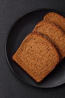 Fresh crispy brown bread sliced from whole grain flour photo