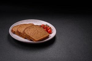 Fresh crispy brown bread sliced from whole grain flour photo