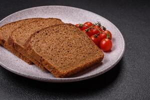 Fresh crispy brown bread sliced from whole grain flour photo